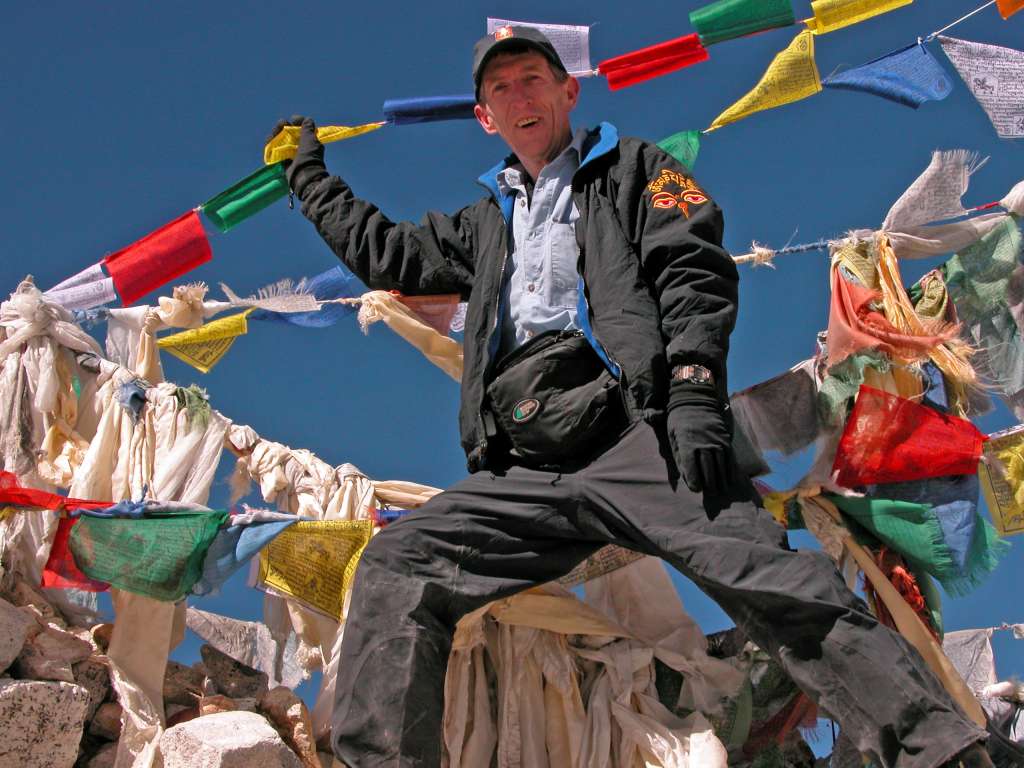 Manaslu 09 02 On The Larkya La The climb overall was fairly straightforward, but seemingly never-ending, I finally reached the Larkya La (5213m) three hours after leaving Larkya Phedi. I immediately began stringing up the prayer flags. A Sherpa stopped and told me I was stringing them up backwards. He explained that the end with the blue prayer flag should be placed at the higher end since blue means sky, and at the other end yellow means earth.